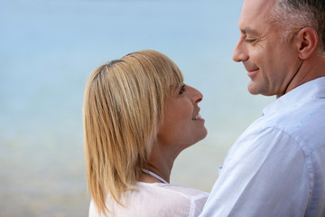 Fototapeta premium Mature couple smiling at the seaside