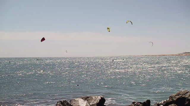 Kitesurfers on the sea, slow motion