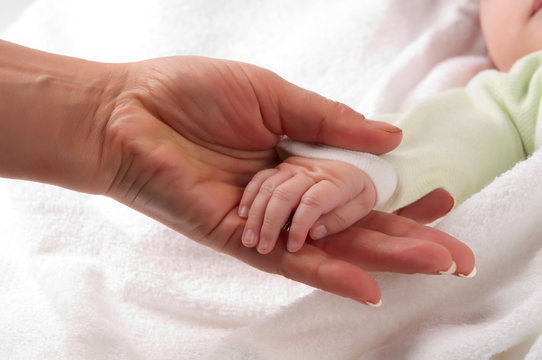 Baby's hand on mother's palm