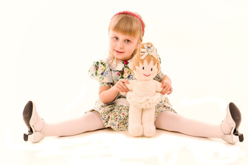 Portrait of happy little girl with a doll © len44ik
