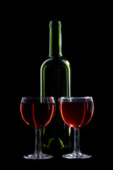 Bottle and glasses on black
