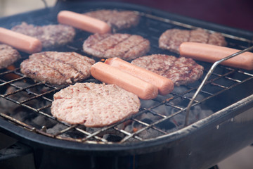Hot dogs and hamburgers on a grill