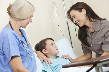 Boy Child Patient In Hospital Bed With Mother & Doctor