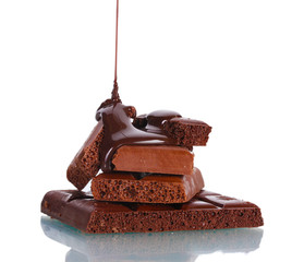 Slices of milk and dark chocolate bar poured chocolate isolated