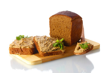 Fresh pate on bread on wooden board isolated on white