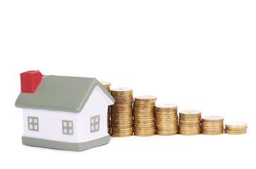 Toy small house and coins in the form of the diagram. concept