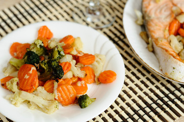 Tasty steamed vegetables on a white plate