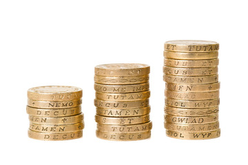 British pound coins in three stacks isolated