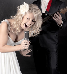 Fashion model in wedding dress with microphone in hand - 40196104