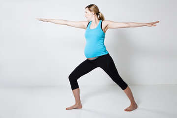 Fototapeta na wymiar Pregnant woman doing yoga exercise