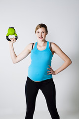 Pregnant woman exercising with kettlebell