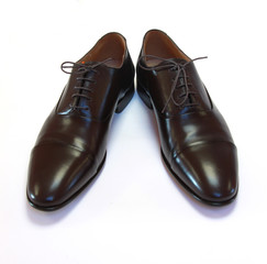 Pair of man's brown shoes isolated on white background