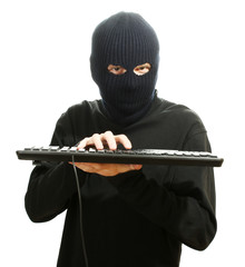 Hacker in black mask with keyboard isolated on white
