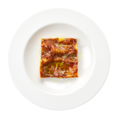Lasagna alla bolognese italian recipe round plate isolated on wh