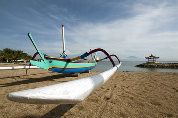 Traditional outrigger fishing boat at a beach in Bali