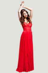 Naklejka premium Beautiful female fashion model posing in red dress