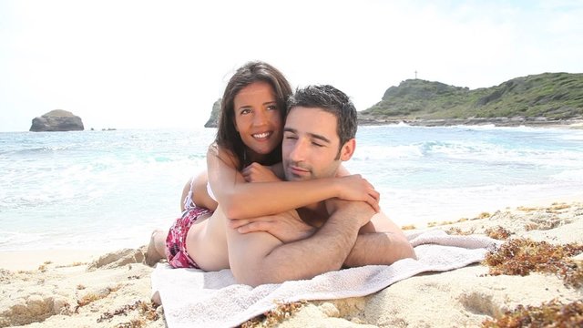 Couple relaxing on a sandy beach
