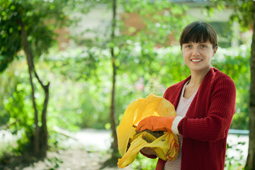 Female farmer fertilizes the soil in garden