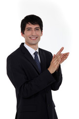 Smiling businessman clapping his hands