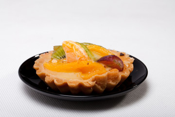 sweet cake with fruits isolated on white