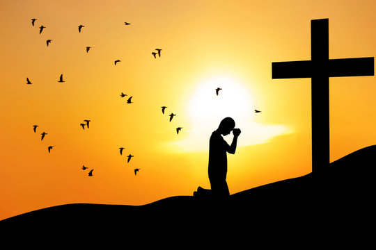Christian background: man praying under the cross