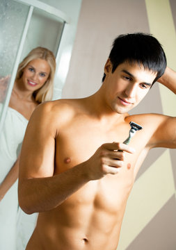 Shaving man and woman at bathroom