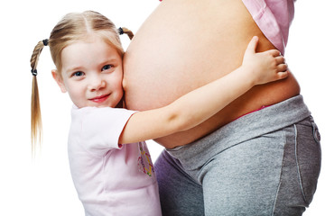 Beautiful pregnant woman with her daughter. Isolated on white