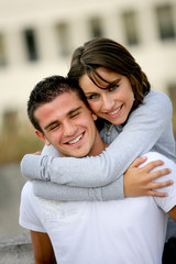 Couple hugging outside building