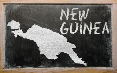 outline map of new guinea on blackboard