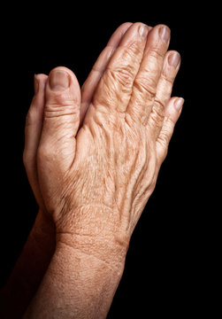 Old wrinkled hands praying