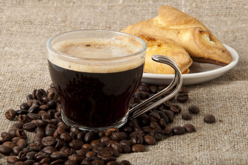 a cup of coffee and pastries with cheese