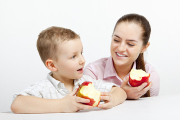 boy and woman are eating apples