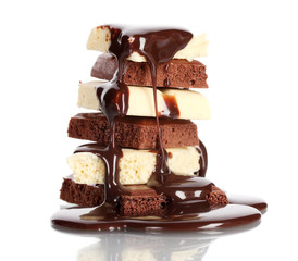 Slices of milk and white chocolate bar poured chocolate isolated