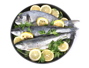 Fresh fishes with lemon, parsley and pepper