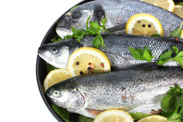 Fresh fishes with lemon, parsley and pepper