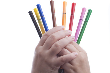 Hand with colorful pens