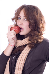 Young beautiful girl bites an apple.