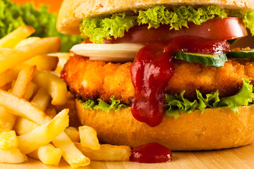 Big hamburger, French fries and vegetables
