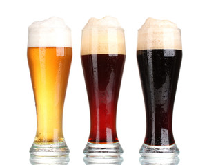 three glasses with different beers isolated on white