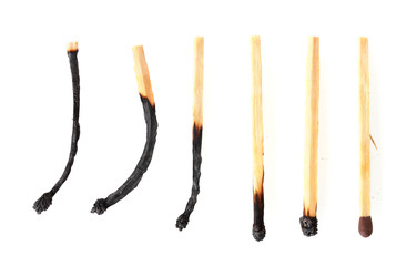 burnt matches and one whole match isolated on white