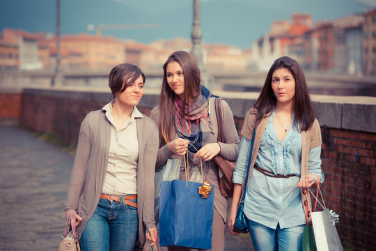 Beautiful Young Women Waliking in the City with Shopping Bags