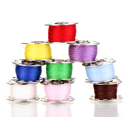 Metal spools of thread isolated on white