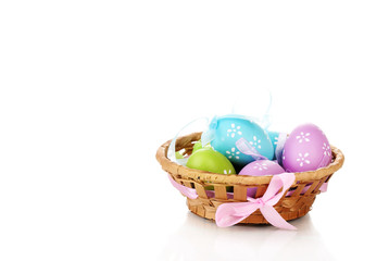 Fototapeta na wymiar Colorful easter eggs in basket isolated on white