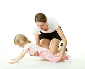 Fototapeta na wymiar Mother teaching little daughter to do sport
