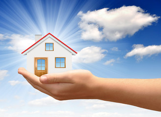 Little House on the hands against the blue sky