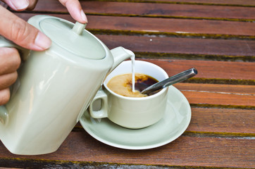 waiters hand serve coffee