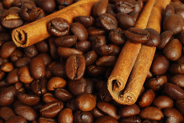 Coffee beans and cinnamon sticks close-up