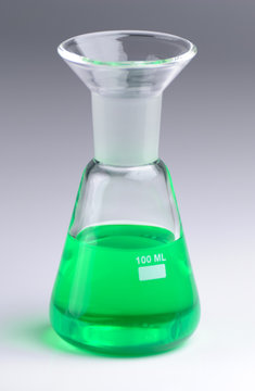 Laboratory beaker filled with green fluid