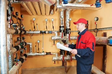 heating engineer repairman in boiler room