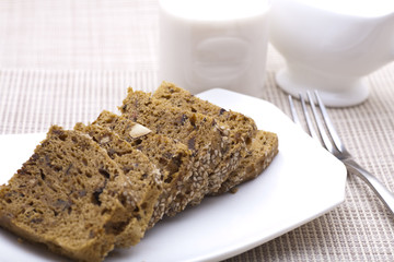 Breakfast cake with fork and milk